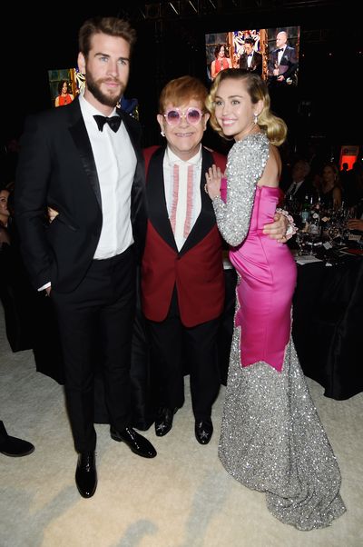 Liam Hemsworth, Elton John and Miley Cyrus in Moschino&nbsp;at&nbsp;Elton John's 2018 Oscars Viewing Bash in honour of the Elton John AIDS&nbsp;Foundation