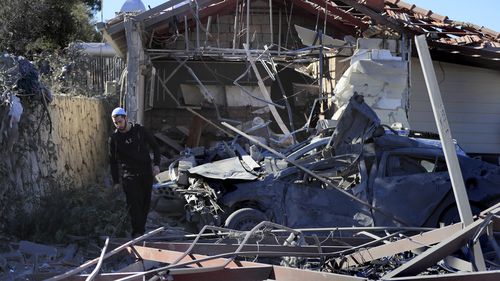 A Druze man walks by the site where an Israeli airstrike hit a compound housing journalists, killing three media staffers from two different news agencies according to Lebanon's state-run National News Agency, in Hasbaya village, southeast Lebanon, Friday, Oct. 25, 2024. (AP Photo/Mohammed Zaatari)
