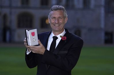 Adam Hills after being made a MBE (Member of the Order of the British Empire) by the Princess Royal, during an investiture ceremony at Windsor Castle, on November 8, 2022 in Windsor, England  