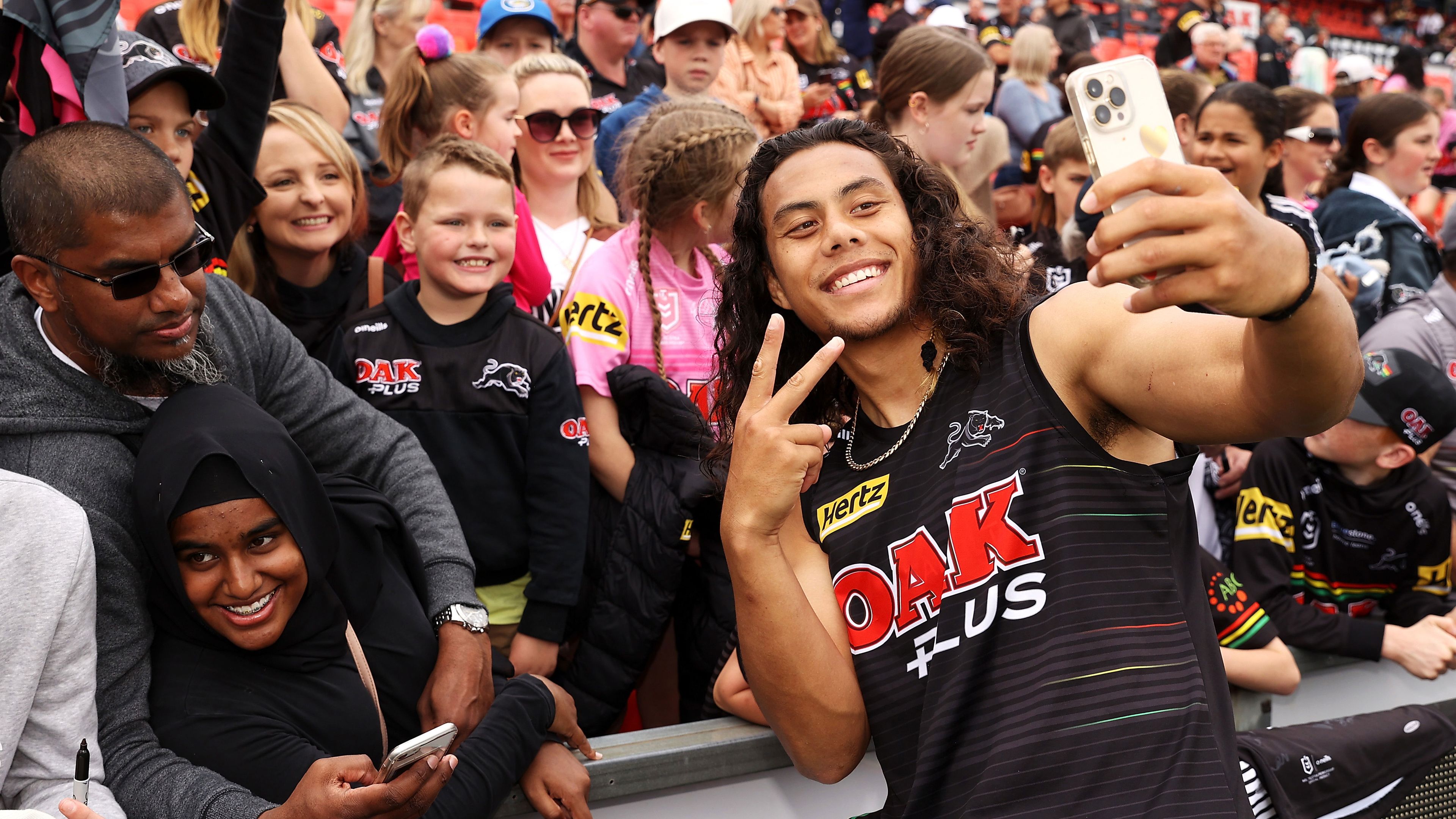 Jarome Luai poses for photographs with supporters after a Panthers training session in grand final week at BlueBet Stadium.
