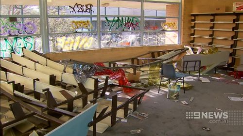 The former library has been trashed with books and furniture strewn across the room. (9NEWS)