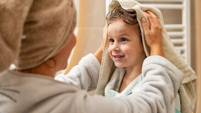 Mum towel drying kid's hair