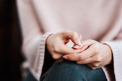 Cropped shot of a woman sitting on a sofa and feeling anxious