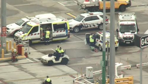 Emergency crews waited for the plane near the gate at Melbourne Airport.