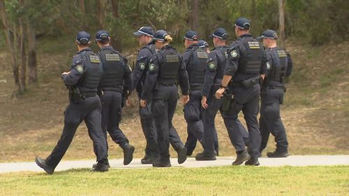 A manhunt for three teenagers plunged a quiet Sydney street into lockdown today after a highway pursuit involving a car police claim was stolen. Goode Street in Currans Hill.