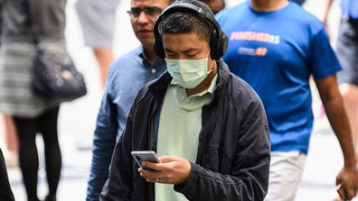 A man wearing a protective face mask seen in Sydney, Monday, March 2, 2020. (AAP Image/James Gourley) NO ARCHIVING