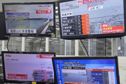 TV monitors show news flash after a powerful earthquake in Russia's Far East prompted tsunami warnings in parts of Japan, in Osaka, western Japan Wednesday, July 30, 2025. (Kai Naito/Kyodo News via AP)