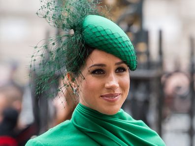 Meghan Markle dressed in green smiling