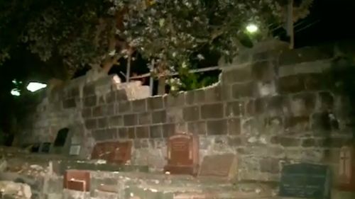 The car ploughed into a wall at the cemetery. (9NEWS)