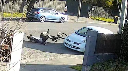 A security camera captured the moment a New Zealand mountainbiker, Mike Evans was deliberately knocked from his bike by the open door of a stolen car that police believe was driven by a child.