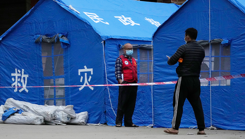 Tents with the words Disaster rescue are seen at the entrance to Lv village which leads into the site of plane crash, Tuesday, March 22, 2022, in southwestern China's Guangxi province.