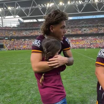 Reece Walsh hugs Indy-Rose on the field