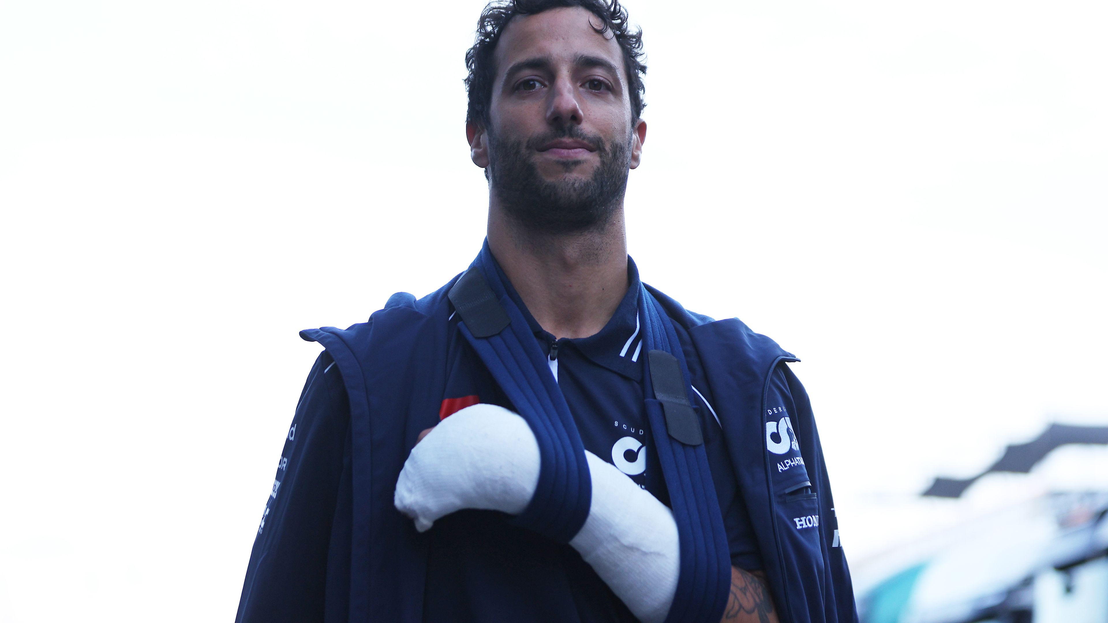 Daniel Ricciardo of Australia and Scuderia AlphaTauri wears a cast on his hand after crashing during practice which has ruled him out of competing in this weekends race ahead of the F1 Grand Prix of The Netherlands at Circuit Zandvoort on August 25, 2023 in Zandvoort, Netherlands. (Photo by Dean Mouhtaropoulos/Getty Images)