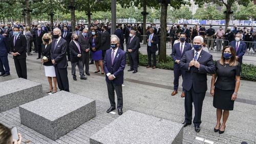 From left, New York Gov. Andrew Cuomo, Democratic presidential candidate and former Vice President Joe Biden, former New York Mayor Mike Bloomberg, and Vice President Mike Pence stand during the national anthem at the National September 11 Memorial and Museum, Friday, Sept. 11, 2020, in New York