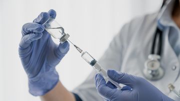 Nurse holding a needle. Injection. Vaccine.