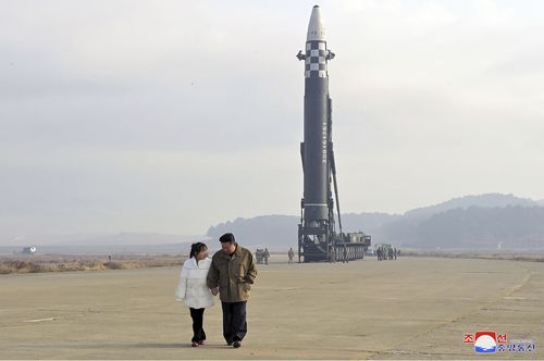 This photo provided on Nov. 19, 2022, by the North Korean government shows North Korean leader Kim Jong Un, right, and his daughter at the site of a missile launch at Pyongyang International Airport in Pyongyang, North Korea, Friday, Nov. 18, 2022