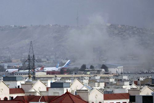 Smoke rises from a deadly explosion outside the airport in Kabul, Afghanistan, Thursday, Aug. 26, 2021. Two suicide bombers and gunmen have targeted crowds massing near the Kabul airport, in the waning days of a massive airlift that has drawn thousands of people seeking to flee the Taliban takeover of Afghanistan. (AP Photo/Wali Sabawoon)