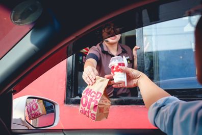 McDonald's employee handing customer food