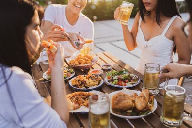 Group holiday party of asian people Eating dinner and drinking beer at home