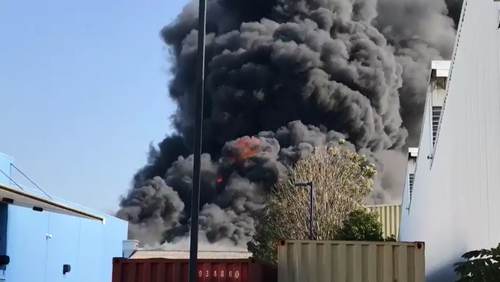 The large fire is producing vast plumes of smoke at the Virginia workshop. (9NEWS)