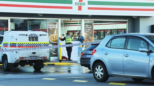 A man is assisting police after an a fatal stabbing at a 7-Eleven petrol station in Perth's northern suburbs.