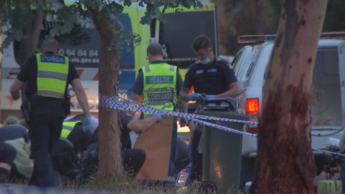 A man is under police guard in hospital after a suspected stabbing police say left a woman dead and a girl fighting for life in Melbourne's north.