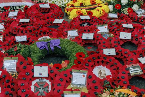 Poppies and other floral wreaths lie, during an Armistice Day ceremony at the Menin Gate Memorial to the Missing in Ypres, Belgium, Friday, November 11, 2022
