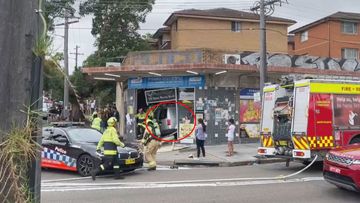 A woman was pinned under a van which crashed into a Homebush convenience store.