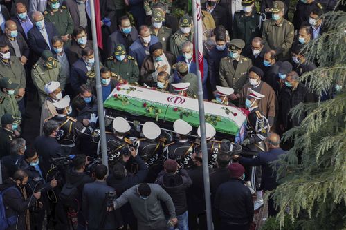 In this photo released by the official website of the Iranian Defense Ministry, military personnel carry the flag draped coffin of Mohsen Fakhrizadeh, a scientist who was killed on Friday, in a funeral ceremony in Tehran, Iran, Monday, Nov. 30, 2020. Iran held the funeral service for Fakhrizadeh, who founded its military nuclear program two decades ago, with the Islamic Republic's defense minister vowing to continue the man's work "with more speed and more power." (Iranian Defense Ministry via A