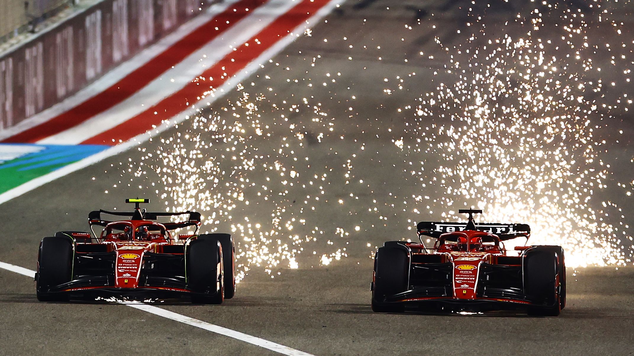 Sparks fly from the cars of Carlos Sainz and Charles Leclerc driving the Ferrari SF-24.