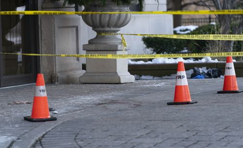 Police cones and tape are seen outside of a condominium building the day after a shooting in Vaughan, Ontario.
