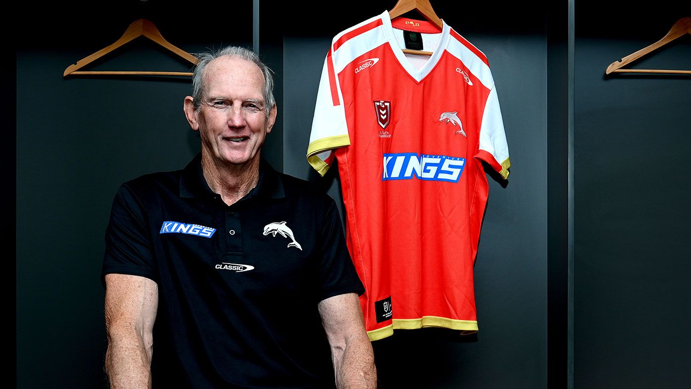 Wayne Bennett poses for a photo with the revealing of the Dolphins Heritage Round jersey