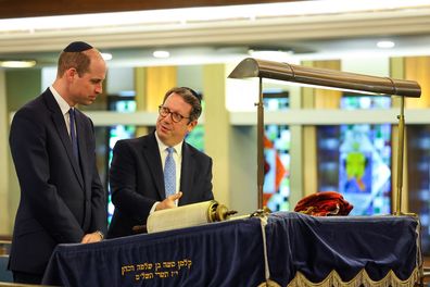 Rabbi Daniel Epstein shows Britain's Prince William, Prince of Wales a 17th century Torah scroll as he visits the Western Marble Arch Synagogue on February 29, 2024 in London