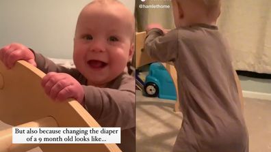 Baby standing holding on to furniture and smiling.