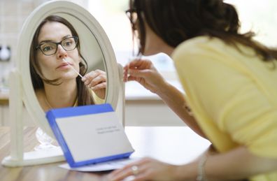 A woman using a rapid antigen test at home.