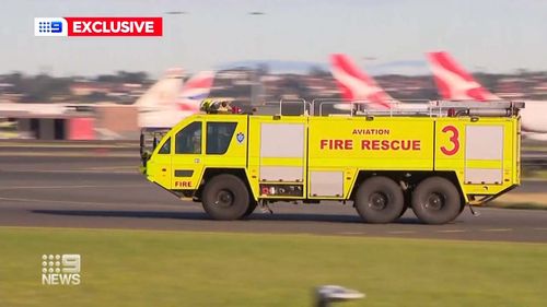 Fire crews rushed to the Qantas plane at Sydney Airport.