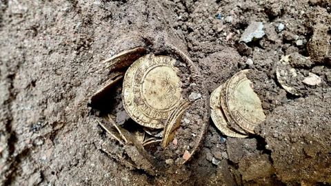 A British couple are $1.3 million richer after an urn of gold coins they found under their kitchen floor caused a bidding frenzy at auction.