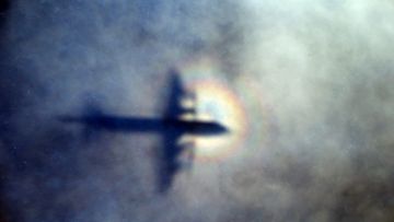 The shadow of a Royal New Zealand Air Force P3 Orion is seen on low level cloud while the aircraft searches for missing Malaysia Airlines Flight MH370. Picture: AP