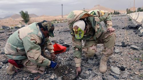 Engineers removing a landmine in Palmyra. (AAP)