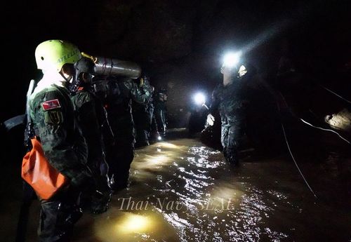 Rescuers are seen here taking supplied into the cave.