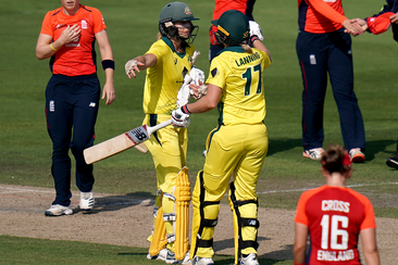 Ellyse Perry celebrates with teammate Meg Lanning.