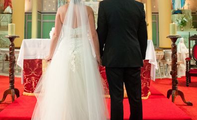 Bride and groom standing at altar