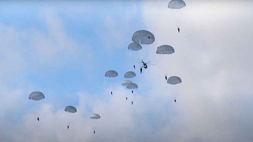 Russian paratroopers jump from military helicopters during joint military exercising near the border with Poland in Belarus.
