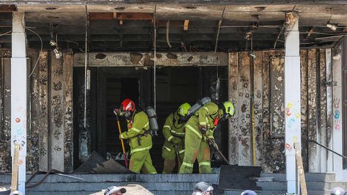 Firefighters sweeping after extinguishing the blaze at Old Parliament House in Canberra.