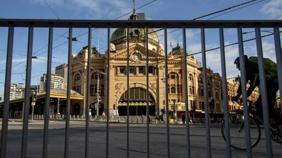 A cyclist passes an empty Flinders Street Station during lockdown due to the continuing spread of the coronavirus in Melbourne.