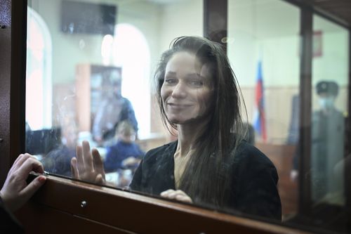 Antonina Favorskaya stands in a glass cage in a courtroom in the Basmanny District Court in Moscow, Russia, Friday, March 29, 2024.