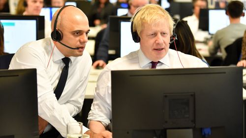 Chancellor of the Exchequer Sajid Javid and Boris Johnson man the phones at the Conservative Campaign Headquarters.
