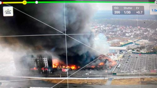 This 2022 aerial image provided by Ukrainian security forces, taken by a drone and shown on a screen, shows a blown-up building near the outskirts of Kyiv.