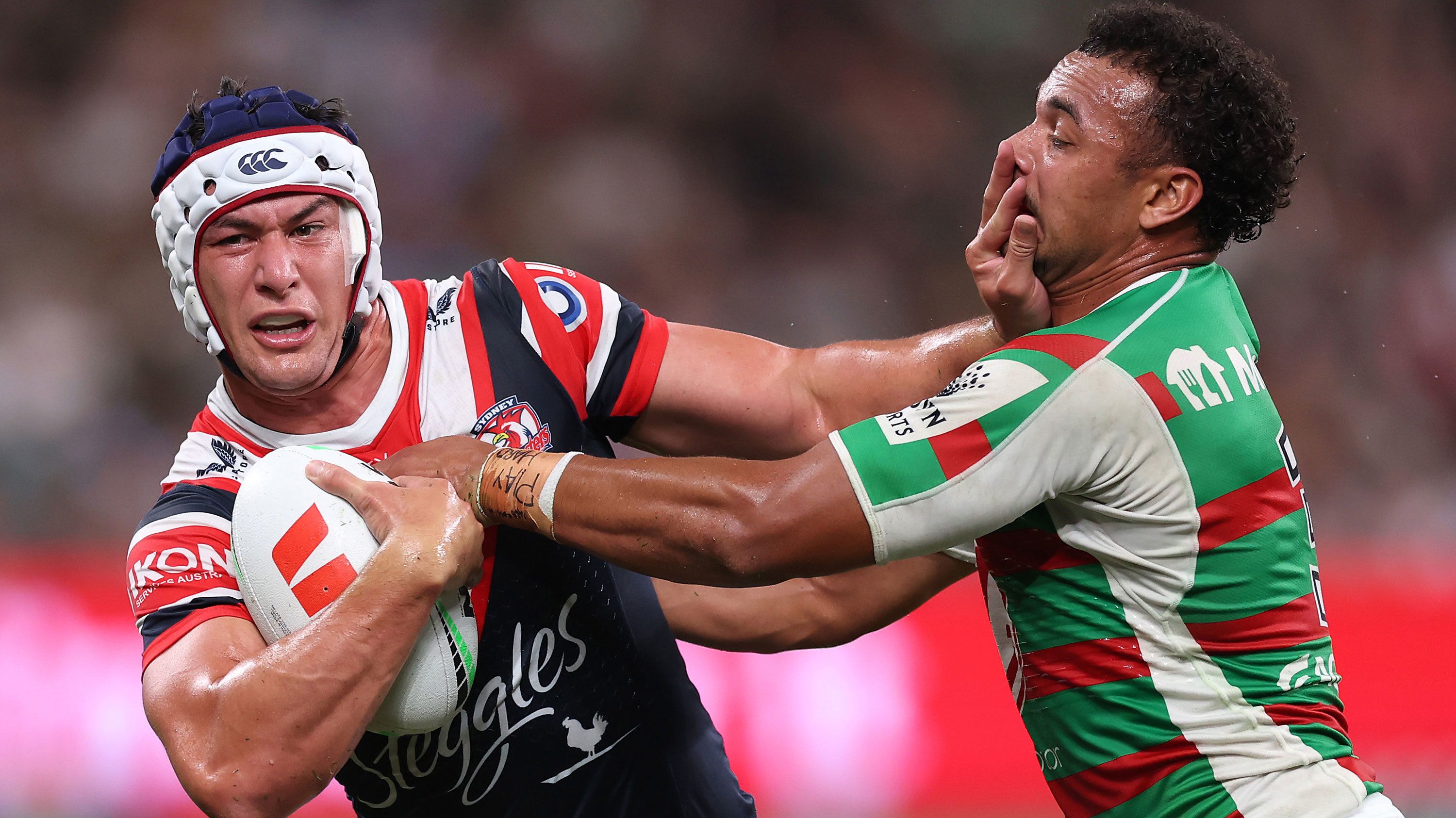 Joseph Manu of the Roosters is tackled by Isaiah Tass of the Rabbitohs during their round three match. 
