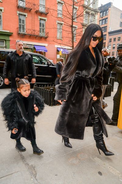 <p>Coat tales: Kim Kardashian West and North West leave their Manhattan hotel in  ebony fur.</p>